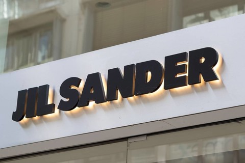 Close-up, logo of the German luxury fashion brand Jil Sander on a boutique in the shopping street