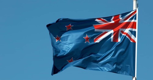 New Zealand Flag Waving in the Wind against blue sky