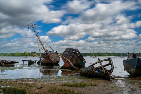 Pin Mill, England - 11 June, 2022: view of the boat graveyard at Pin Mill on the River Orwell in