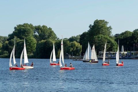 Symbolic picture weather, leisure activities in summer, sailing school, sailing boats in front of a