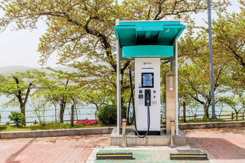An electric vehicle charging station located by a lake with trees around, in Suncheon, South Korea,
