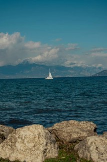 A sailing boat on Lake Garda in the sunshine, Sirmione, Lake Garda, Italy, Europe