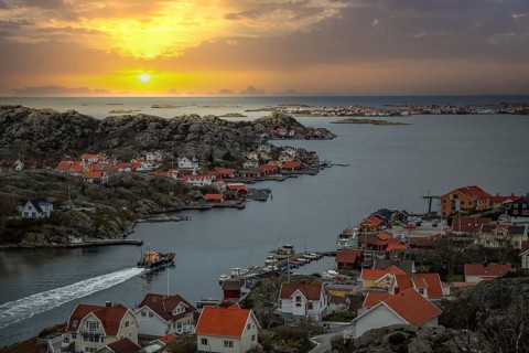 Beautiful typical Scandinavian village that winds around a coastal strip in a bay. Wintery