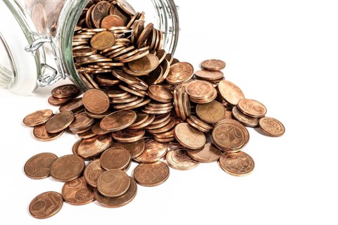 small change euro cent coins pouring out of glass jar isolated on white background, withdrawal of