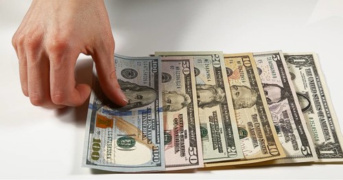 Hands of Woman and Dollar Banknotes