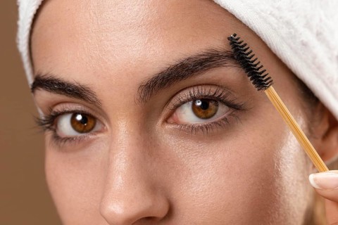 Young woman taking care her eyebrows