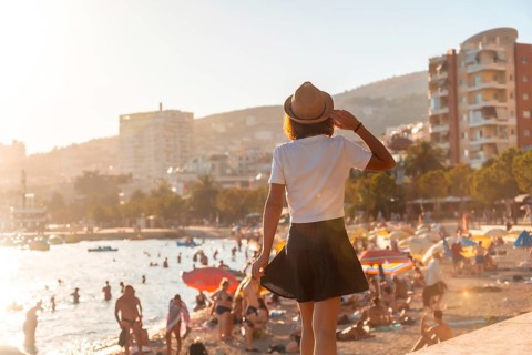 Portrait of a tourist woman in the sunset of Sarande or Saranda in the Albanian riviera walking