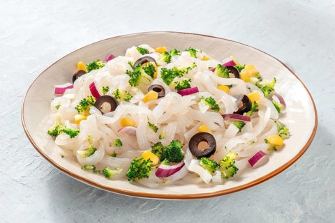 Konjac pasta, a plate of low-calorie fettuccine with broccoli, onions, and other vegetables, a