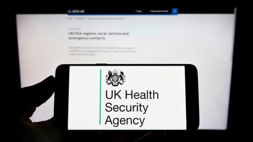 Stuttgart, Germany, 05-26-2022: Person holding cellphone with logo of agency UK Health Security