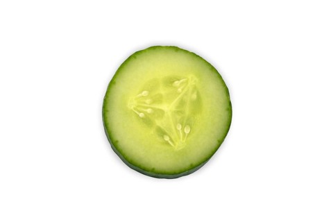 Close-up of a single cucumber slice, Freshly sliced cucumber close-up on a white background