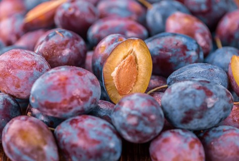 Portion of fresh Plums close-up shot, selective focus