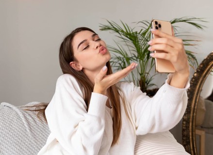 Woman with mobile taking selfie
