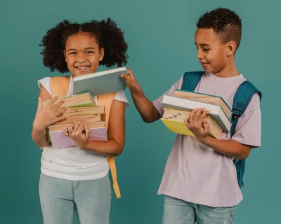 Boy helping his friend with books