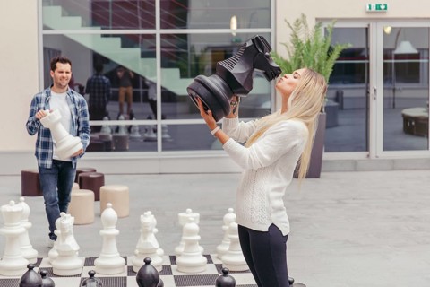 Girl kissing chess horse by chess board