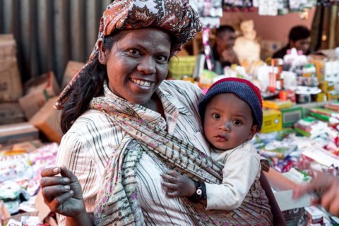 Toba Batak woman with baby in traditional clothing on the weekly market of Pangururan, the main