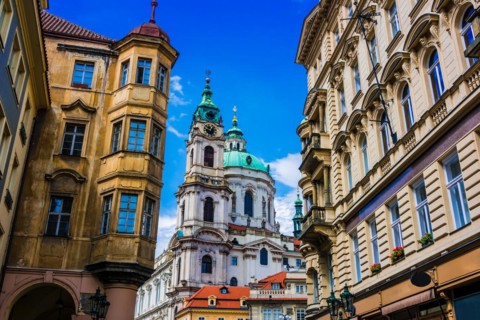 Historic architecture of downtown Prague, Czech Republic. Mostecka Street with St Nicholas Bell