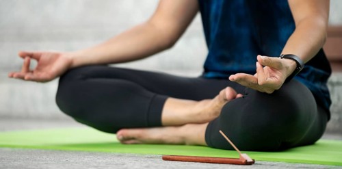 Man lotus position practicing yoga