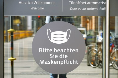 Hannover, Germany - May 21, 2020: German language sign on entrance door to shopping center advises