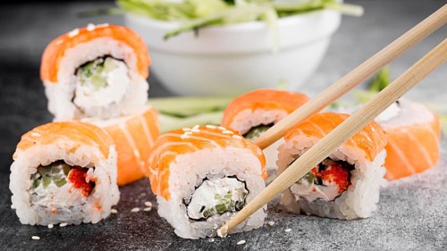 Salad fresh sushi rolls chopsticks