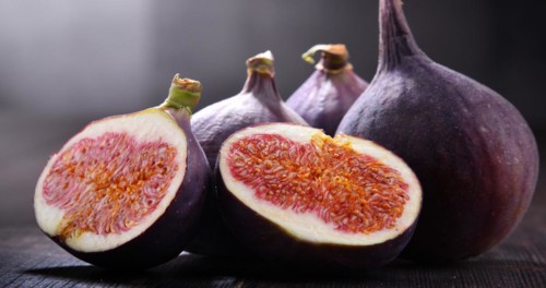 Composition with fresh figs on wooden table