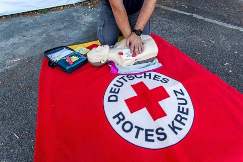 DRK (German Red Cross) staff demonstrating how to use an AED (automated external defibrillator) or