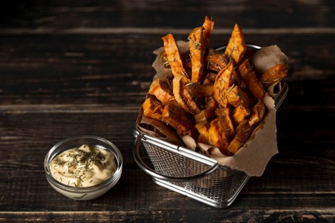 High angle sweet potato fries with sauce