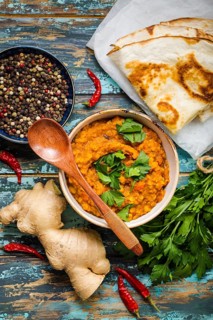 Traditional Indian lentils Dal, naan butter bread, fresh coriander. Indian Dhal spicy curry in