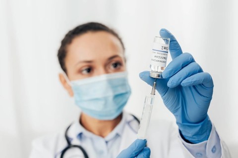 Close up woman with syringe serum