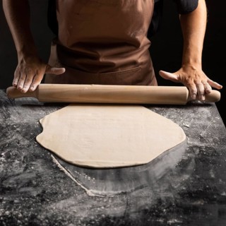 Chef using rolling pin dough