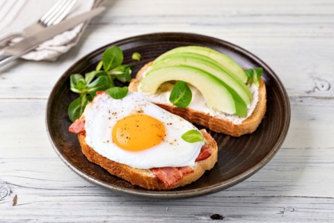 toast with fried egg on a wooden table