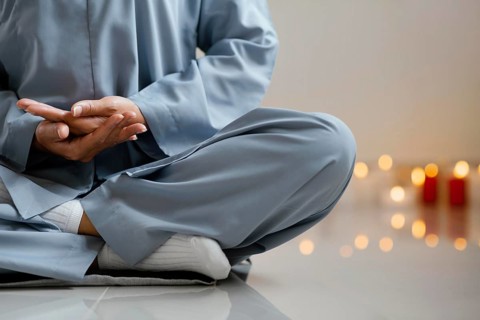 Front view woman meditating candles