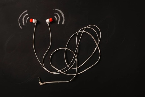 Sound wave icon near earphone blackboard. High resolution photo