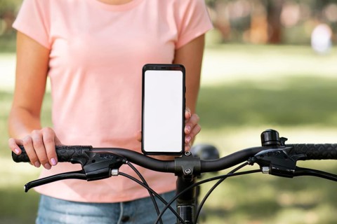 Woman with bicycle copy space mobile phone