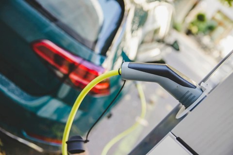 Electric car recharging with charge cable and plug leading to charge point
