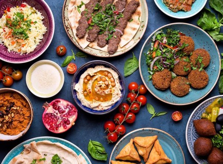 Middle eastern or arabic dishes and assorted meze, concrete rustic background. Meat kebab, falafel,