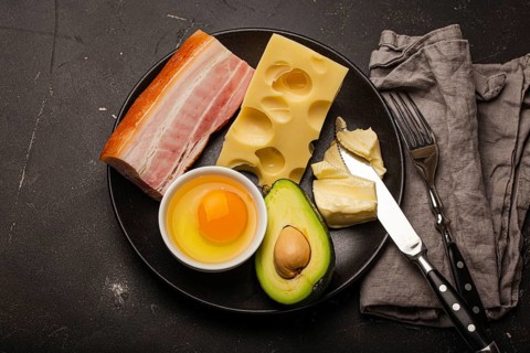 Main keto foods as butter, olive oil, fried egg, avocado, cheese, fat meat bacon for ketogenic diet