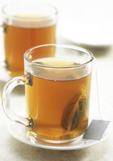 Cup of green tea, infusion against white background