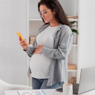 Side view pregnant woman home with laptop smartphone