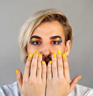 Man wearing make up cosmetics nail polish close up