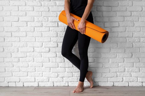 Close up hands holding yoga mat
