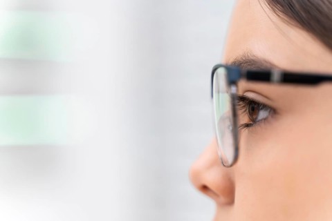 Girl store trying glasses close up