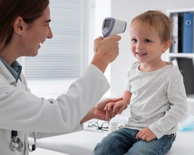 Doctor checking baby s temperature