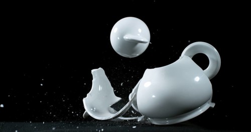Tea-Pot falling and exploding on Black Background