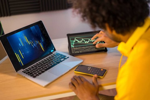 Rear view of an unrecognizable businessman working in cryptocurrency from home office