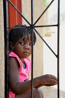 Himba girl in a house in the Himba district of Otuzemba, Otuzemba, Opuwo, Kaokoland, Kunene,