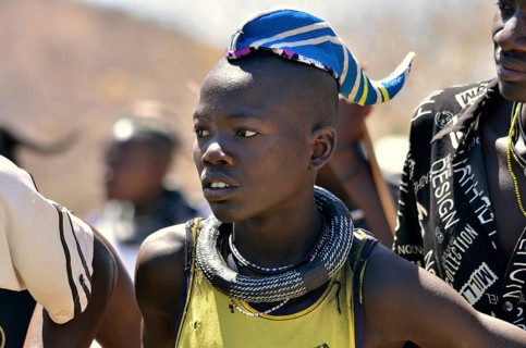 Young Himba man wearing a traditional headdress, cap in the form of a cattle horn, Omohanja,