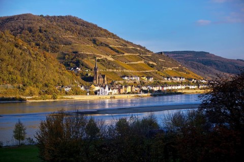 View across the Rhine in the late evening light from Bacharach to Lorch with the parish church of