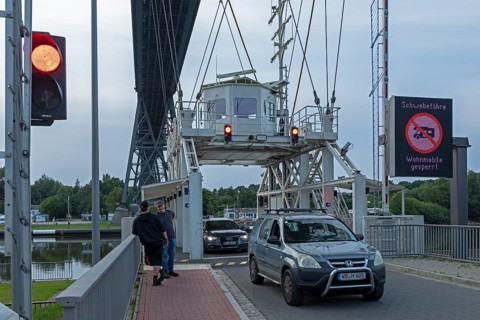 Cars leaving transporter bridge, red traffic light, high bridge, Kiel Canal, Rendsburg,