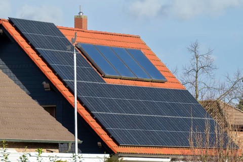 Weathercock in front of a house roof with photovoltaics, Kamen, North Rhine-Westphalia, Germany,