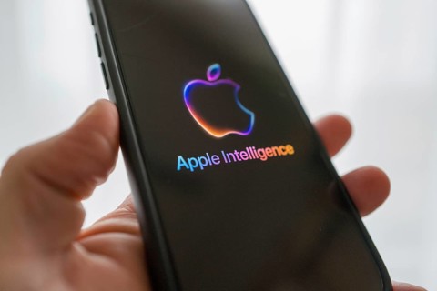 Hand holding iPhone with Apple logo and the text 'Apple Intelligence', bright and modern